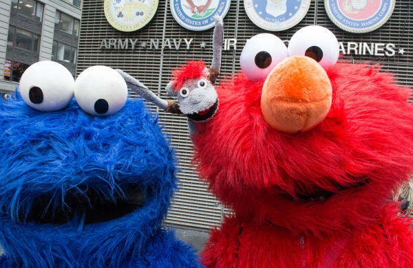 Tyrone snaps a photo with Cookie Monster and Elmo.