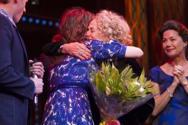 Katie Brayben receives a hug from Carole King on stage at the Aldwych Theatre.
