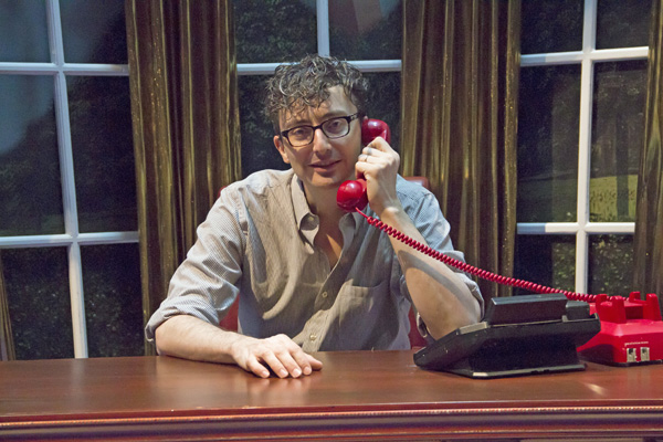 Beowulf Boritt takes a very important call at the president&#39;s desk in Clinton the Musical, directed by Dan Knechtges, at New World Stages.