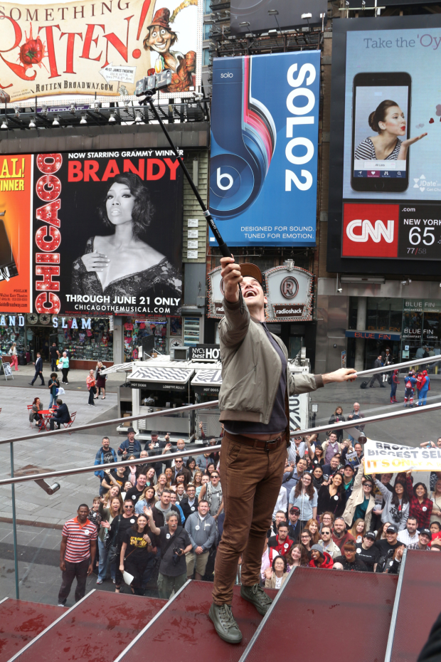 Micah Stock atop the red Times Square steps as he takes Broadway&#39;s biggest selfie.