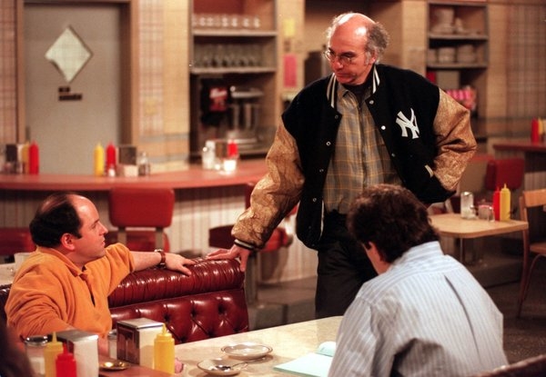 Larry David chats with Jason Alexander and Jerry Seinfeld on the set of the 1990s television sitcom Seinfeld.