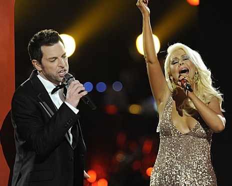 Chris Mann and his television coach Christina Aguilera singing a duet during season two of The Voice.