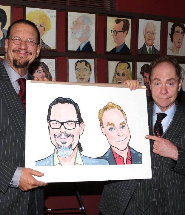 Penn &amp; Teller proudly show off their new Sardi&#39;s caricatures.