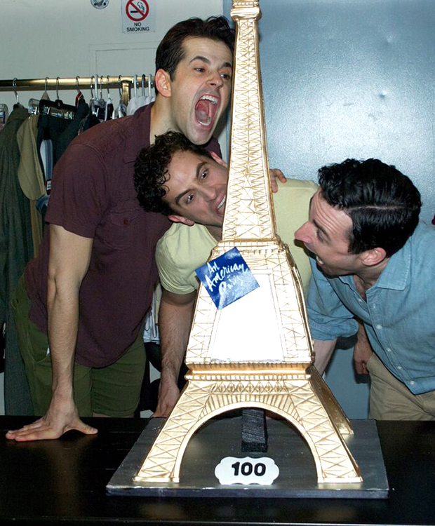Robert Fairchild, Brandon Uranowitz, and Max Von Essen go to town on an Eiffel Tower-shaped cake to celebrate the 100th performance of Broadway&#39;s An American in Paris.