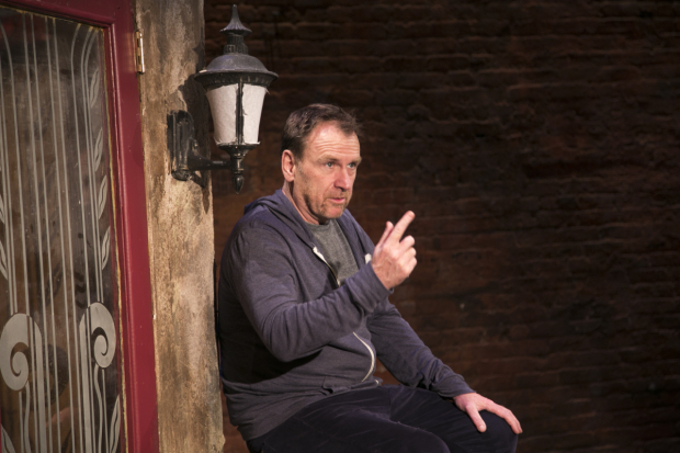 Colin Quinn poses under a Manhattan street light in his solo show Colin Quinn The New York Story.