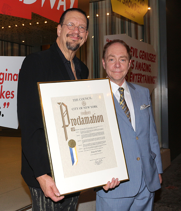 Penn and Teller pose with their New York City Council Proclamation.