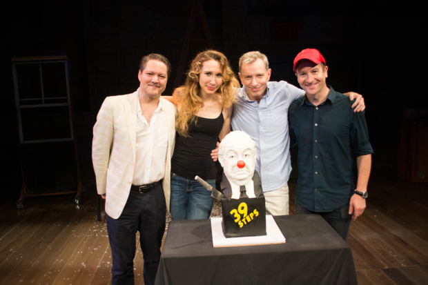 39 Steps cast members Robert Petkoff, Brittany Vicars, Arnie Burton, and Billy Carter with the Hitch-cake.
