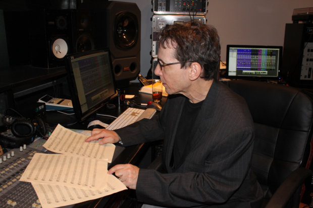 Larry Hochman studies a piece of music in the studio.