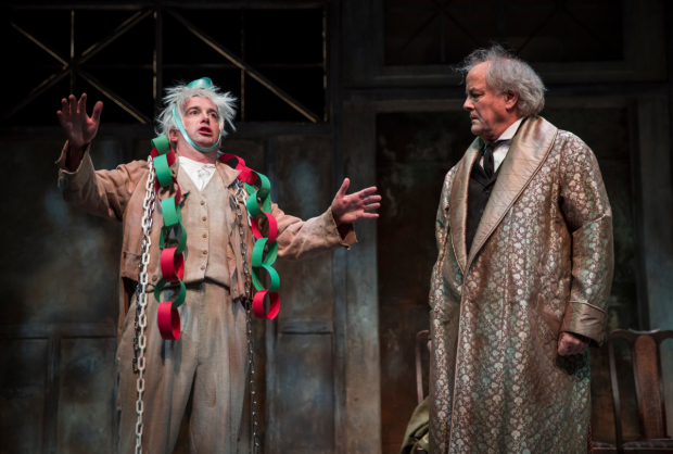 Peter Gwinn (Jacob Marley) and Francis Guinan (Scrooge) in The Second City's Twist Your Dickens at the Goodman Theatre.