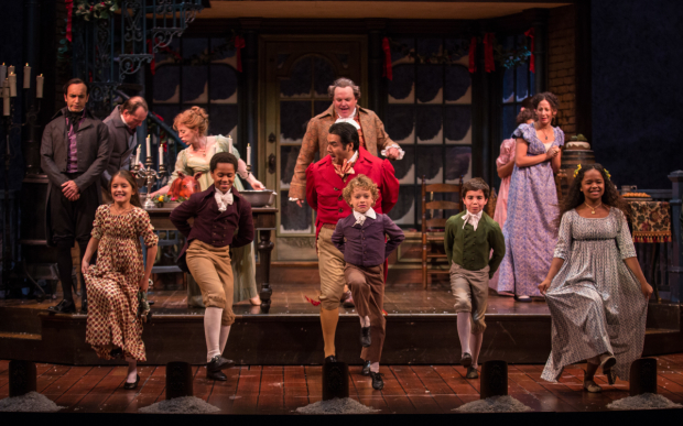 Kareem Bandealy (Young Scrooge), Amaris Sanchez (Emily Cratchit), Phillip Cusic (Peter Cratchit), J. Salome Martinez (Dick Wilkins), Nathaniel Buescher (Tiny Tim), Aaron Lamm (Boy Scrooge), and Skye Sparks (Belinda Cratchit) take the stage at the Goodman Theatre.