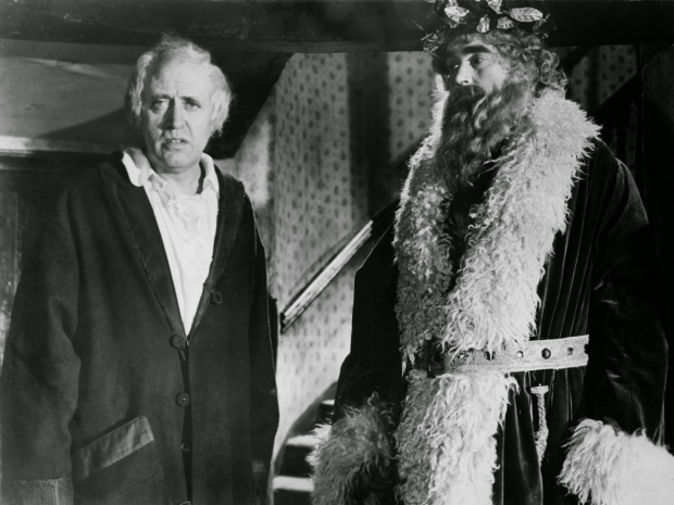 Alastair Sim as Ebenezer Scrooge and Francis De Wolff as the Spirit of Christmas Present in the well-known 1951 film version of Charles Dickens&#39; A Christmas Carol. The classic tale, as well as its author, have become synonymous with the holiday season.