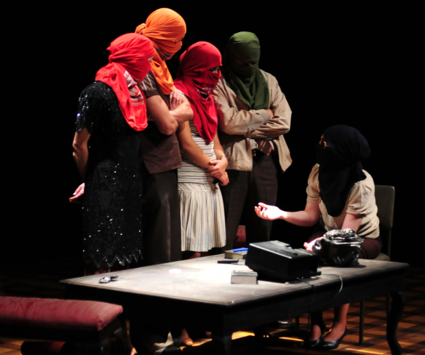 Five actors play masked trainee terrorist in Escuela, written and directed by Guillermo Calderón for Under the Radar at the Public Theater.