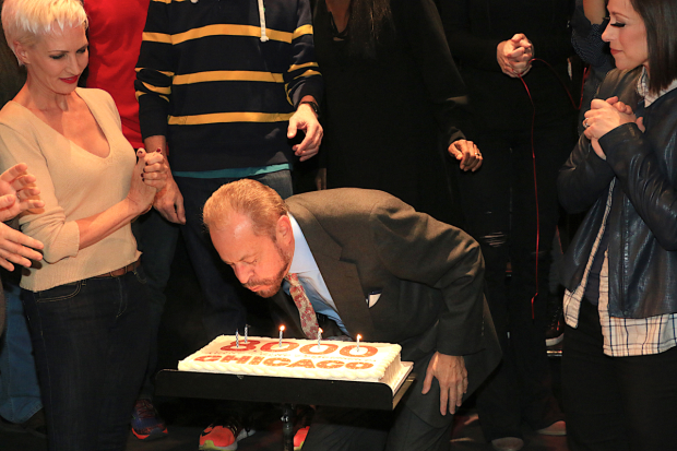 Barry Weissler blows out the candles on cake to celebrate his birthday.