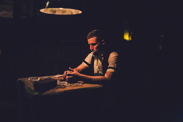 A lonely card game takes place in Sleep No More, directed by Felix Barrett and Maxine Doyle, at the McKittrick Hotel.
