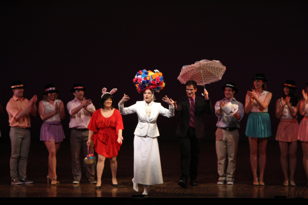 As Ann Harada and Seth Rudetsky look on, Marin Mazzie presents a bonnet during the 2013 Easter Bonnet Competition.