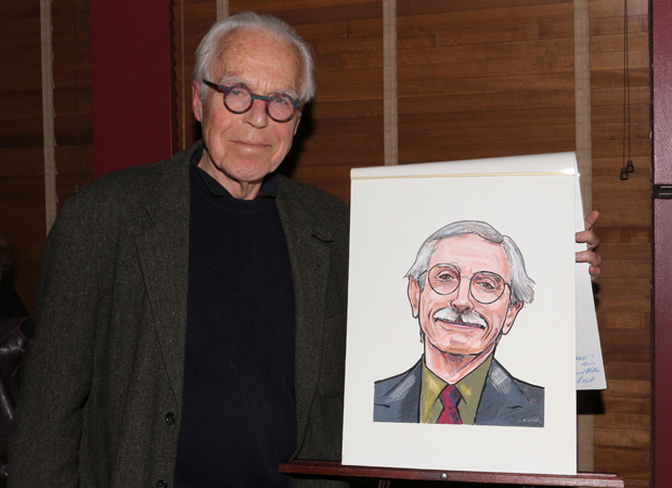 Playwright John Guare proudly shows off his friend&#39;s caricature.