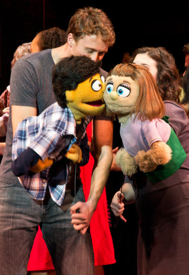 Princeton gives a big kiss to his costar Kate Monster during a curtain call of off-Broadway&#39;s Avenue Q.