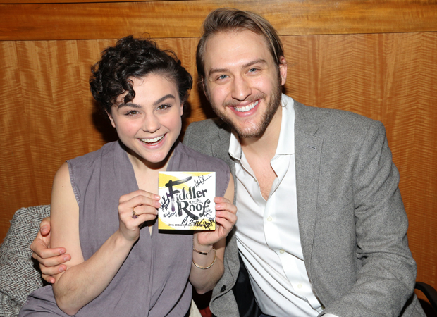 Melanie Moore and Nick Rehberger pose with a signed copy of the Fiddler on the Roof 2016 cast recording.