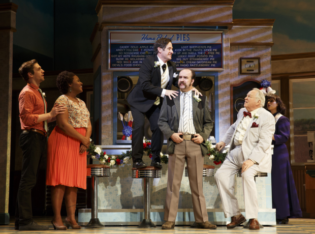 Christopher Fitzgerald (center) leads a rousing production number from Waitress.