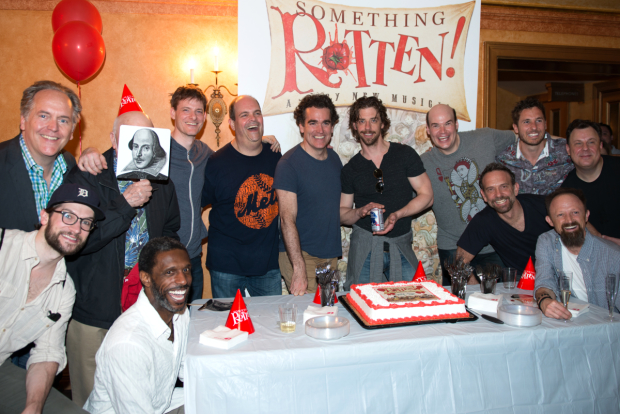 The men of Something Rotten pose with the show&#39;s anniversary cake.