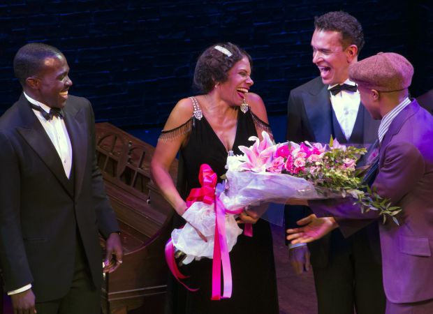 As Joshua Henry and Brian Stokes Mitchell look on, Audra McDonald is surprised with a beautiful bouquet of flowers.