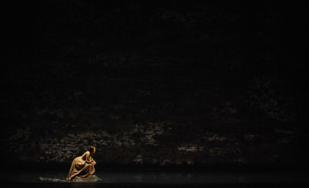 Keira Knightley crouches on some rocks in the river in Thérèse Raquin.