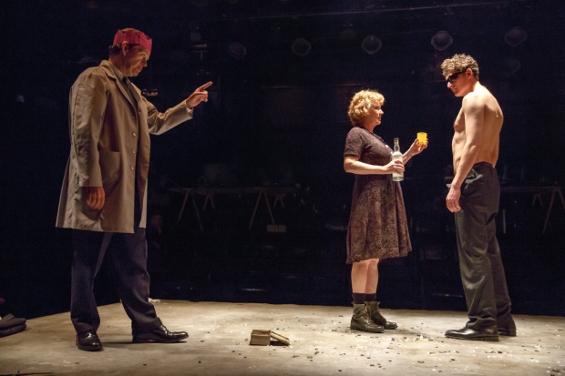 Dylan Baker, Becky Ann Baker, and Gabriel Ebert perform on a stage covered in buttons in Peer Gynt.