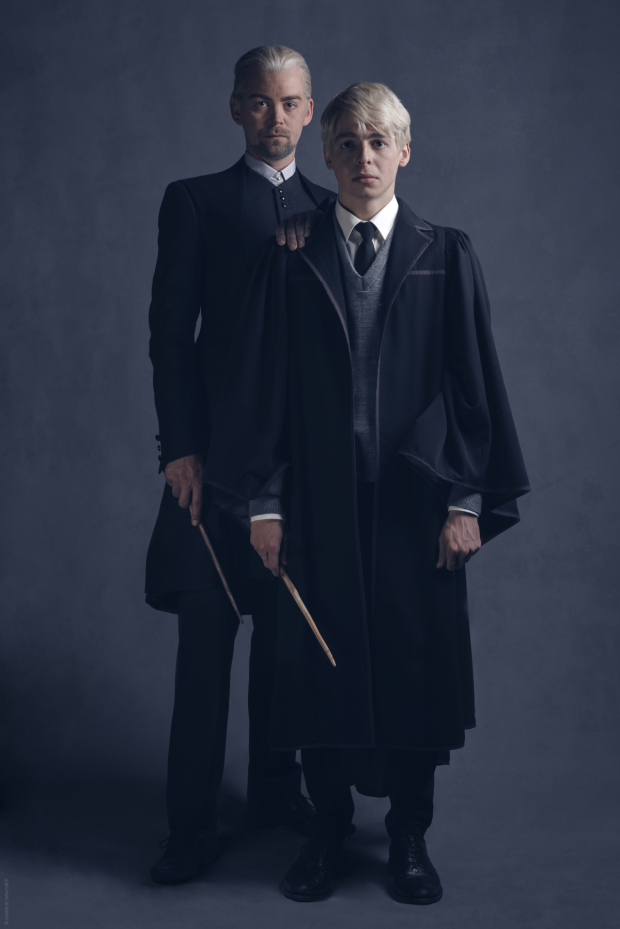 Father and son pose for a Malfoy family photo.