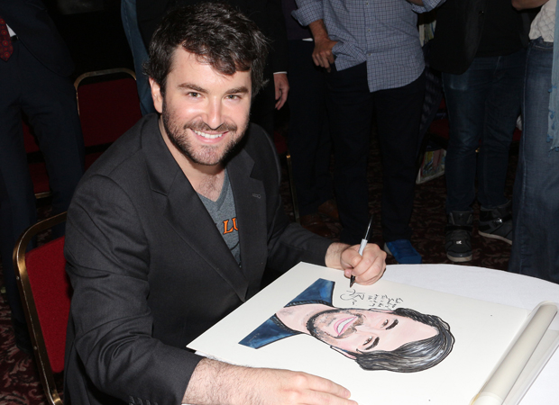 Alex Brightman signs his caricature.