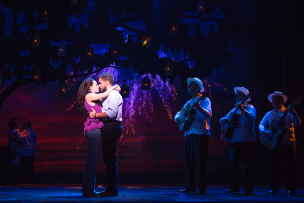 Ana Villafañe and Josh Segarra enjoy a fireworks display in On Your Feet! at the Marquis Theatre.