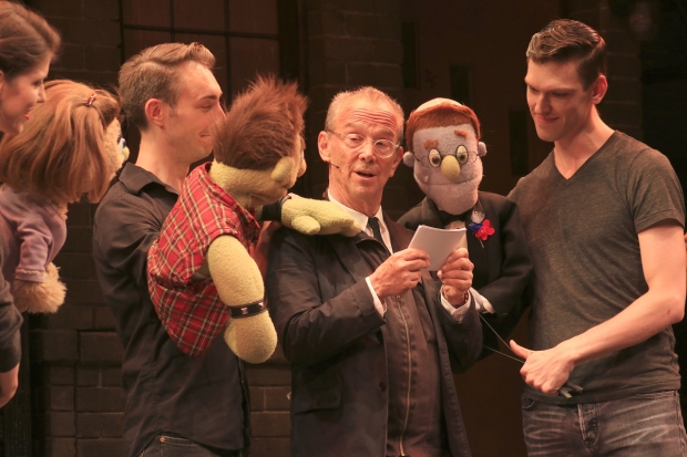 Joel Grey officiates a vow renewal between Avenue Q characters Ricky and Rod.