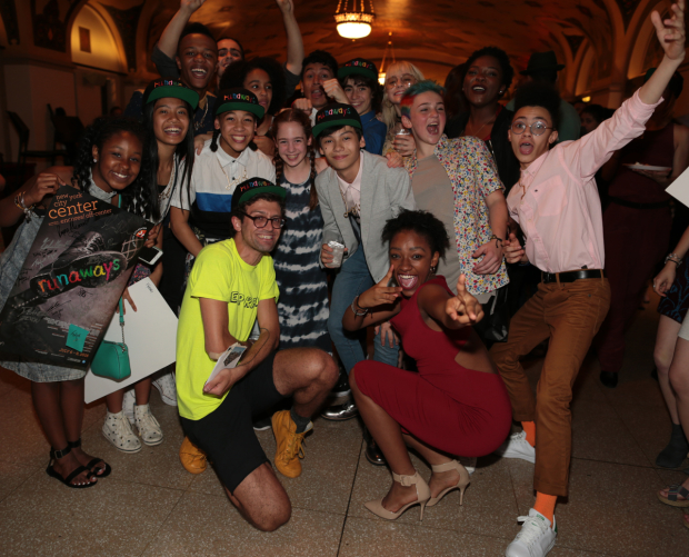 Runaways director Sam Pinkleton (in yellow) with his young cast at New York City Center.