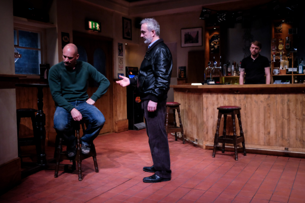 Jimmy (Patrick O&#39;Kane) listens to Ian (Declan Conlon) as Robert (Robert Zawadzki) stealthily observes from behind the bar in Quietly.