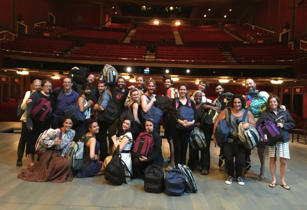 The cast of Fiddler on the Roof with their Operation Backpack contributions on the stage of the Broadway Theatre.