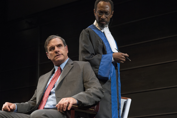The Prosecutor (Michael Rogers) questions former president George W. Bush (Tony Carlin) in The Trial of an American President.