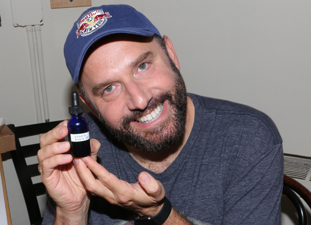 Adam Danheisser holds up a special beard oil made by his wife.