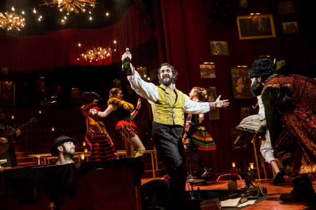 Music director Or Matias and Paul Pinto look on as Josh Groban raises a bottle in Natasha, Pierre &amp; The Great Comet of 1812.