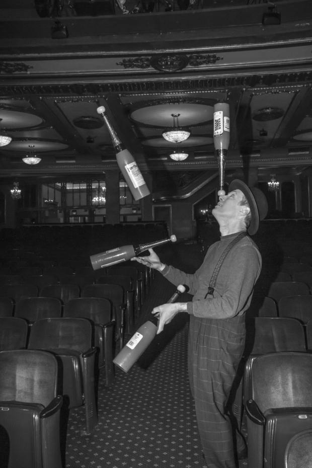 Charlie Frye juggles bowling pins in the orchestra section of the Palace Theatre.