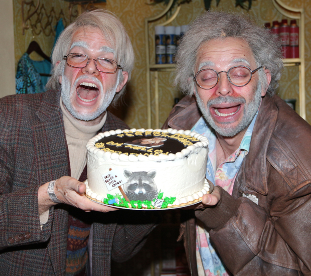 George St. Geegland (John Mulaney) and Gil Faizon (Nick Kroll) show off the Oh, Hello anniversary cake.