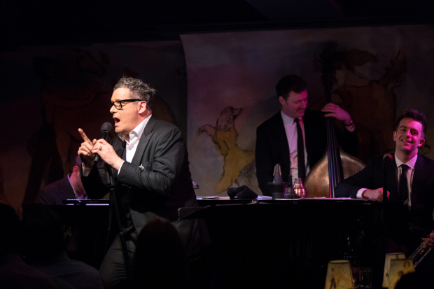 Isaac Mizrahi (foreground) sings his Café Carlyle debut backed by Ben Waltzer, Neal Miner, and Benny Benack III.