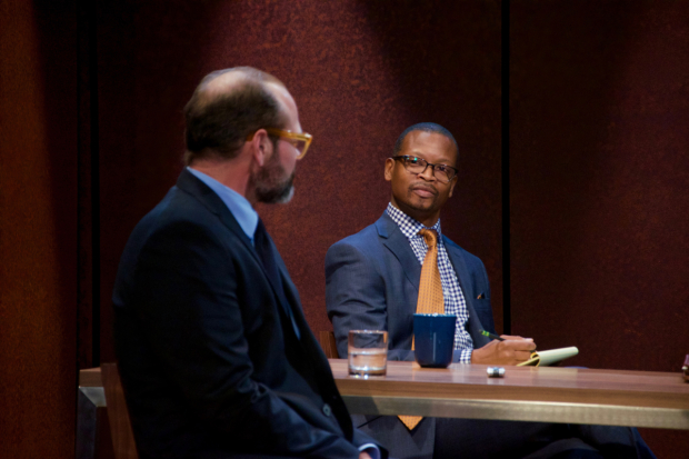 An attorney (Lawrence Gilliard Jr., right) interrogates Charles (Chris Bauer) about his belief in the Bible in The Penitent.