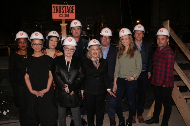 Lynn Nottage, Anna D. Shapiro, Young Jean Lee, Paula Vogel, Jon Robin Baitz, Carole Rothman, Kenneth Lonergan, Bess Wohl, Will Eno, and Trip Cullman pose in hardhats at the Helen Hayes Theatre.