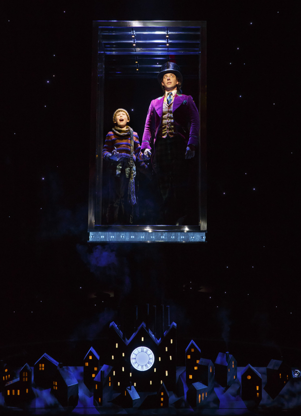 Charlie (Jake Ryan Flynn) and Willy Wonka (Christian Borle) ride in a great glass elevator in the final scene of Charlie and the Chocolate Factory on Broadway.