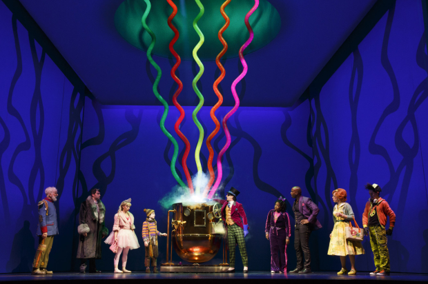 Willy Wonka (Christian Borle, center) demonstrates one of his inventions in Charlie and the Chocolate Factory.