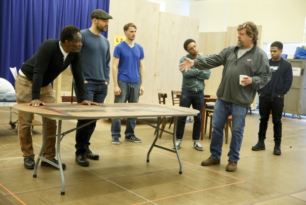 Oskar Eustis (second from right) directs company members in a rehearsal for Julius Caesar, beginning performances June 12 at the Delacorte Theater.