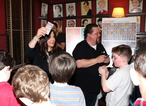 Dori Berinstein and Justin &quot;Squigs&quot; Robertson pass out Lights of Broadway show cards.