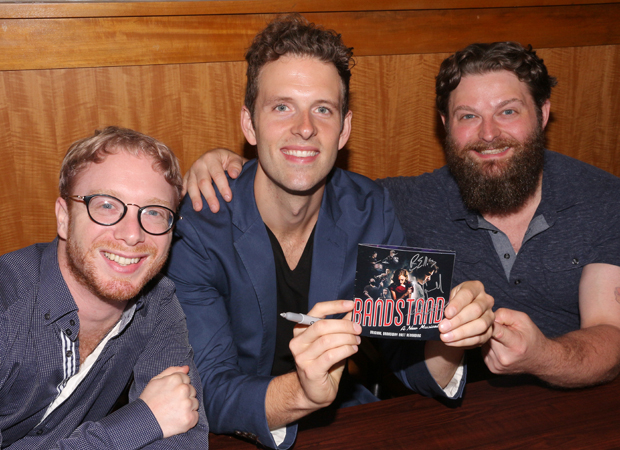Alex Bender, Joe Carroll, and Brandon James Ellis hold up CDs bearing their signature.