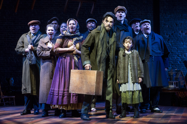 Tateh (J. Anthony Crane) and his daughter (Frances Evans) with fellow immigrants coming to America in Ragtime.