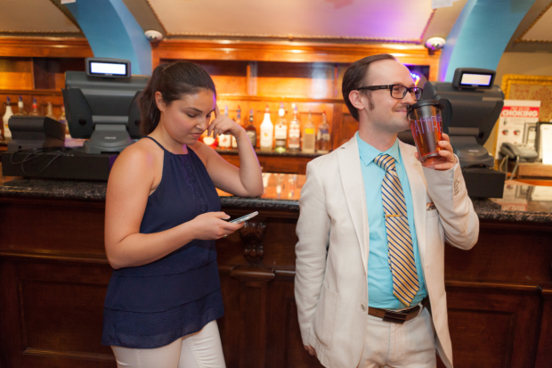 Hayley checks her e-mail while waiting for intermission to end, while Zach sips a refreshing beverage at the Brooks Atkinson Theatre.