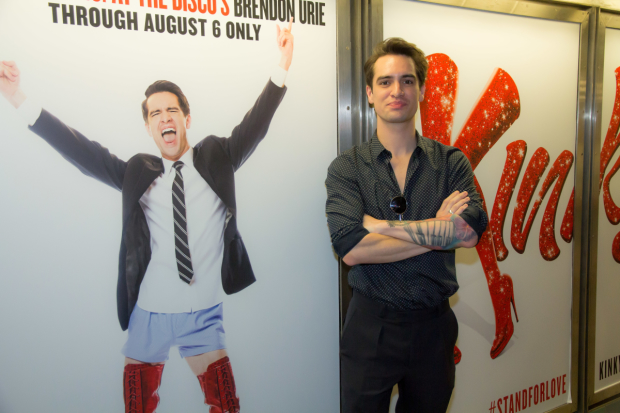 Panic! At the Disco&#39;s Brendon Urie stands next to his subway ad for Kinky Boots.